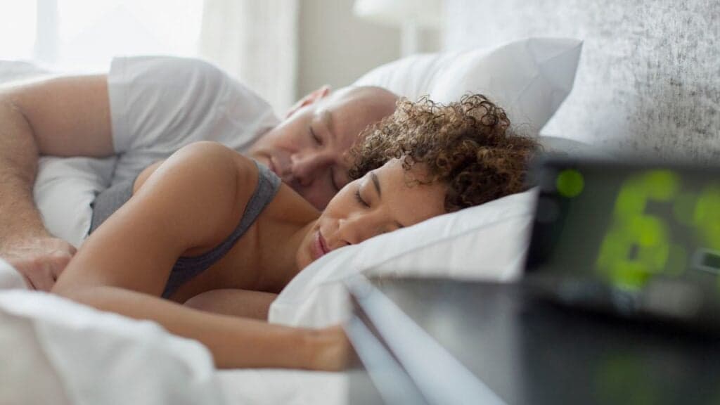 A couple sleeping in bed