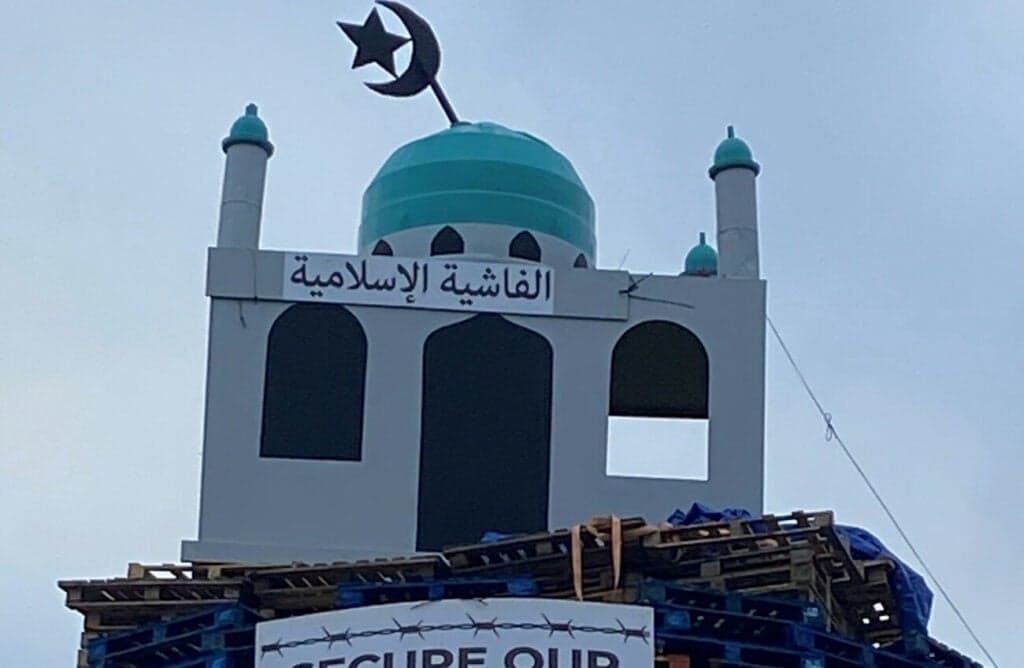 Man arrested amid calls for removal of mosque effigy on bonfire