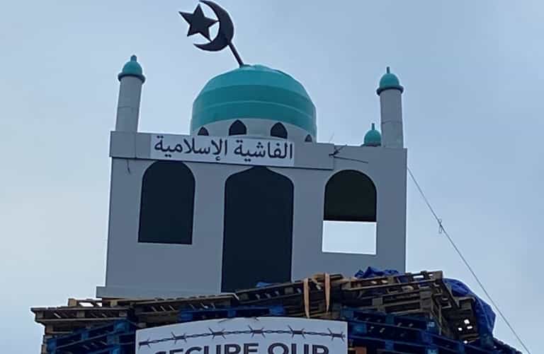 Man arrested amid calls for removal of mosque effigy on bonfire Man arrested amid calls for removal of mosque effigy on bonfire