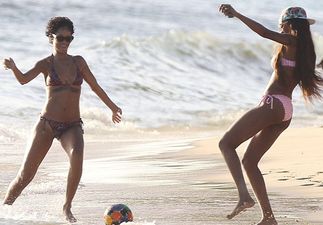 Pics: Rihanna showcases her football and beering skills at the same time