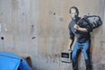 VIDEO: Banksy paints mural on the side of a primary school and the kids love it