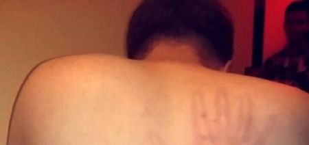 PIC: You can almost feel this man’s pain after his mates forcibly slapped his back
